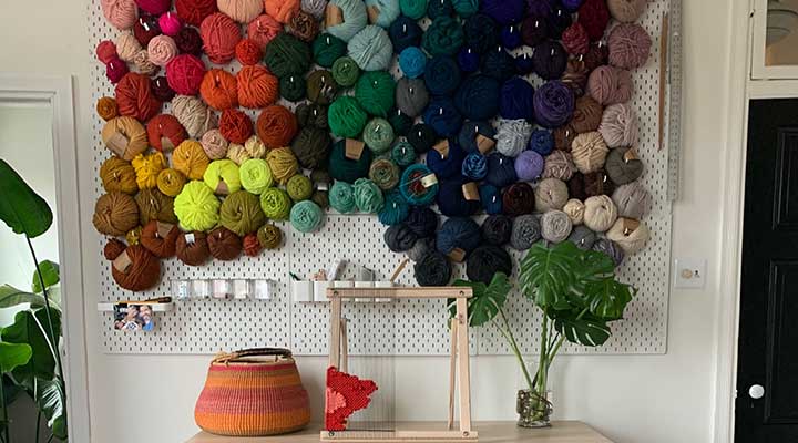 Ikea Skadis pegboard storage panels used for yarn wall in a home